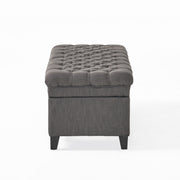 Noble House Juliana storage ottoman with beige fabric and birch wood legs, versatile seating and hidden storage.
