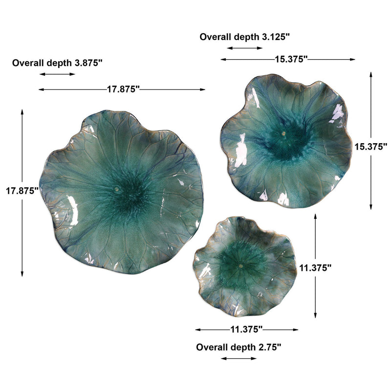 Set of three blue ceramic flower wall decor by Uttermost, showcasing detailed, vibrant floral ceramic art for wall decoration.