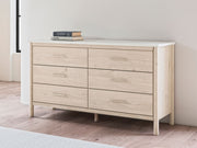 Signature Design by Ashley Cadmori six-drawer dresser with wood finish and modern style, featuring sleek metal handles.