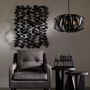 Uttermost black forged iron wall art featuring stacked stone design for modern wall decor.