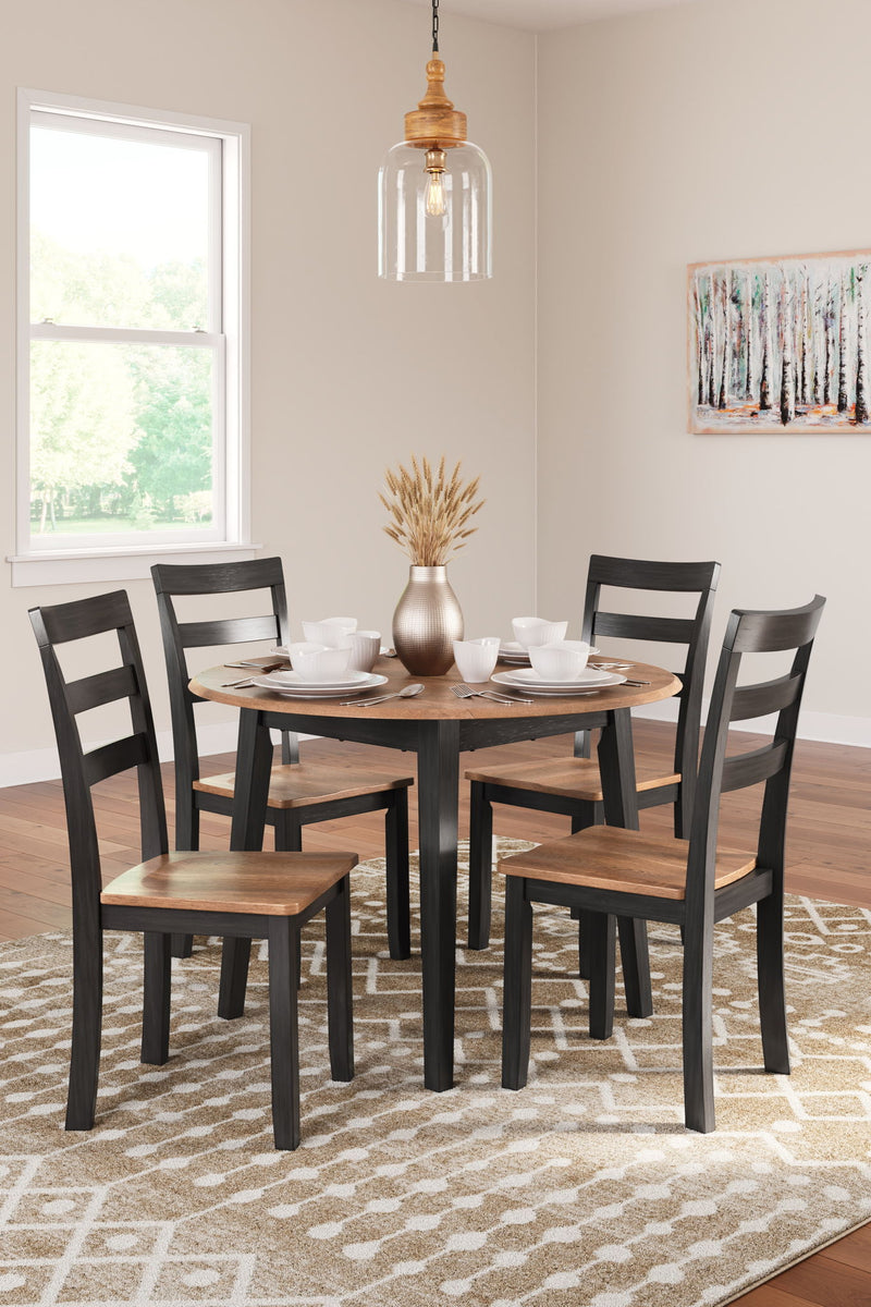 Round dining room drop leaf table set by Signature Design by Ashley, includes five pieces with chairs and table in a classic wood finish.