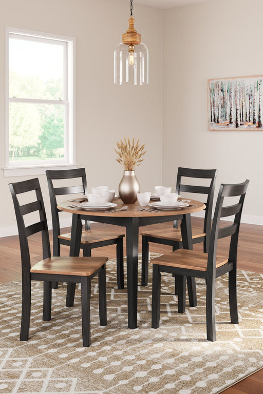 Round dining room drop leaf table set by Signature Design by Ashley, includes five pieces with chairs and table in a classic wood finish.