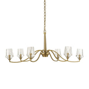 Uttermost Barcelona 6-light brass chandelier with gold finish, featuring elegant curved arms and clear glass shades.