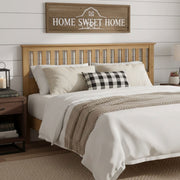 Ridgecrest Home Malinda panel headboard with sleek, modern design in neutral fabric, mounted on a bed frame in a contemporary bedroom setting.