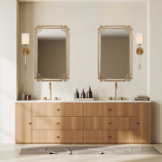 Devoll wall mirror by Uttermost with an antique gold finish, featuring a sleek, rectangular frame and reflective glass surface.