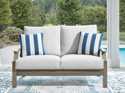 Signature Design by Ashley Rainier Ranch loveseat with cushion, brown and beige upholstery, featuring plush seating and a sturdy frame.