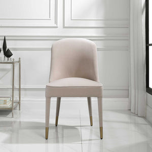 Set of two armless chairs by Uttermost featuring modern design and neutral fabric upholstery.