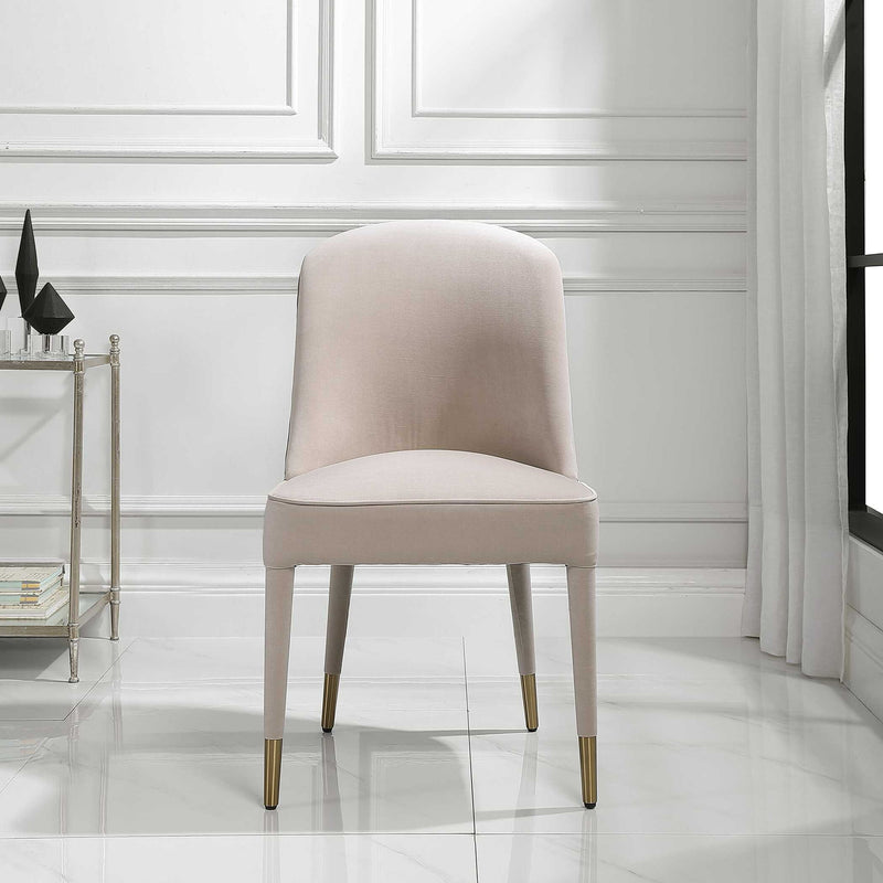 Set of two armless chairs by Uttermost featuring modern design and neutral fabric upholstery.