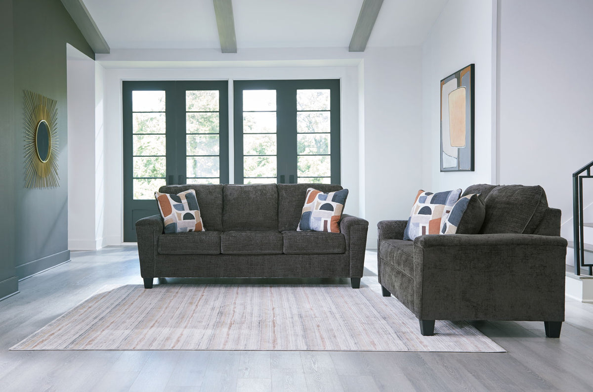 Benchcraft® Erinslane living room set with stationary chair and ottoman, featuring plush upholstery and modern design.