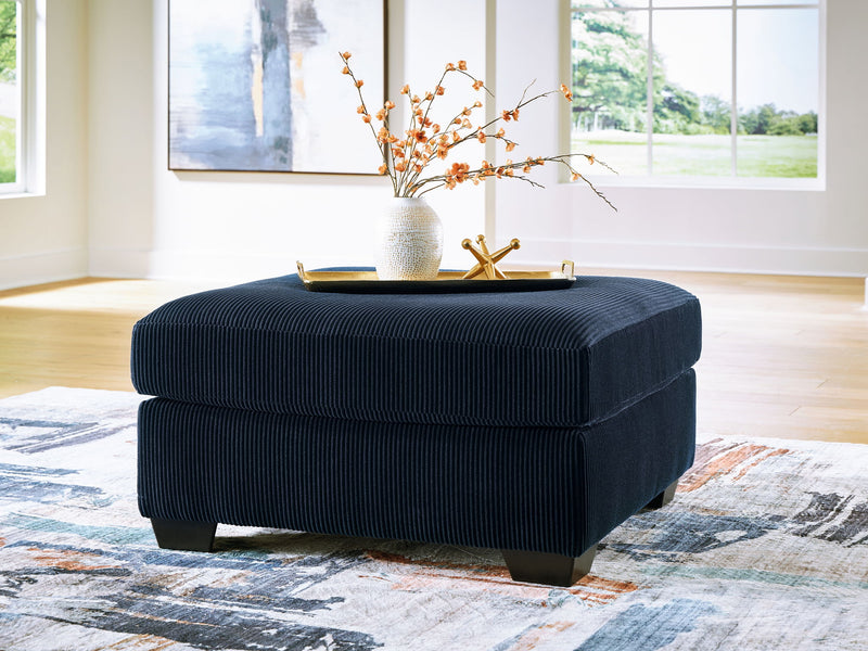 SimpleJoy oversized accent ottoman by Signature Design Ashley, beige fabric with tufted top and wooden block legs.