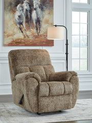 Signature Design by Ashley Stayfish rocker recliner in beige fabric, showcasing its plush cushioning and wooden base.