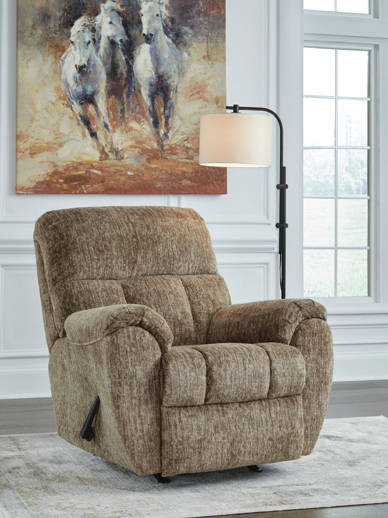 Signature Design by Ashley Stayfish rocker recliner in beige fabric, showcasing its plush cushioning and wooden base.