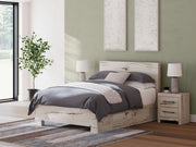 Signature Design by Ashley Lawroy panel bed with built-in storage drawers in a modern bedroom setting.