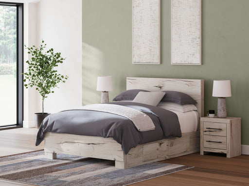 Signature Design by Ashley Lawroy panel bed with built-in storage drawers in a modern bedroom setting.