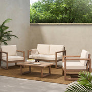 Noble House 4-piece acacia wood outdoor furniture set with beige cushions, includes porch chairs and coffee table for backyard or balcony.