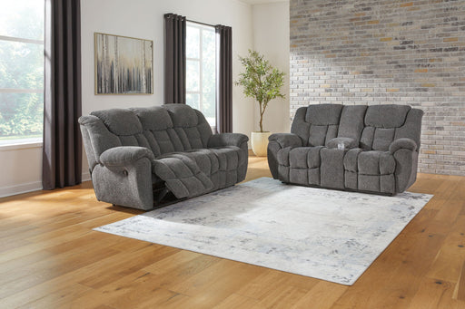 Signature Design by Ashley reclining living room set with plush sofas and loveseats, featuring padded armrests and reclining mechanisms.