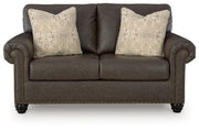 Benchcraft Roxmere living room set with stationary chair and matching ottoman, featuring plush upholstery and modern design.