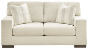 Signature Design by Ashley Maggie stationary loveseat with plush cushions and modern fabric upholstery, perfect for cozy living rooms.