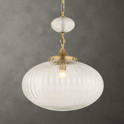 Uttermost Bellaire 1-light pendant with gold finish and glass shade, hanging from a ceiling fixture in modern pendant lighting style.