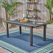 Noble House outdoor expandable dining table with square legs, featuring a sleek wooden surface and extendable design for outdoor meals.