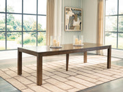 Benchcraft Marxmore rectangular brown dining table with butterfly extension, shown with extended leaves and smooth wood surface.
