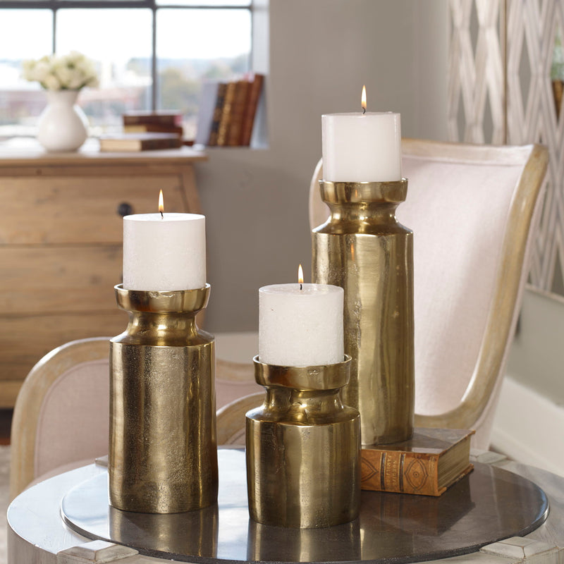 Set of 3 Amina candleholders in antique brass with sculptural, artistic design from Uttermost, perfect for decorative display.