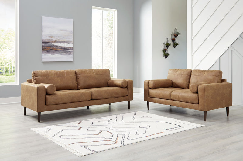 Stationary living room chair with matching ottoman from Signature Design by Ashley, featuring plush upholstery and modern design.