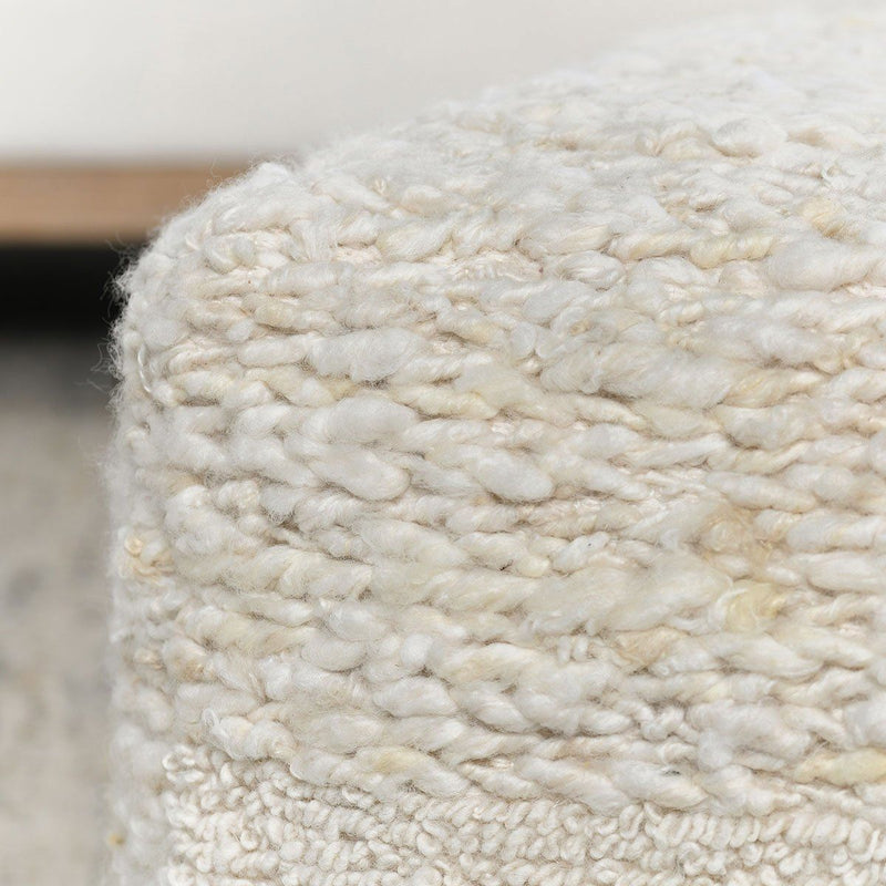 Ivory Sinclair accent pouf by Classic Home, soft fabric, round shape, and plush cushioning for versatile home decor.