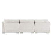 Luxurious L-shaped Modern Cloud sectional sofa by Luxe & Co. with oversized chaise and two free pillows, seating four comfortably.