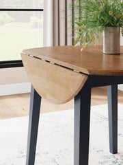 Round dining room drop leaf table by Signature Design by Ashley, featuring a wooden surface and classic design.