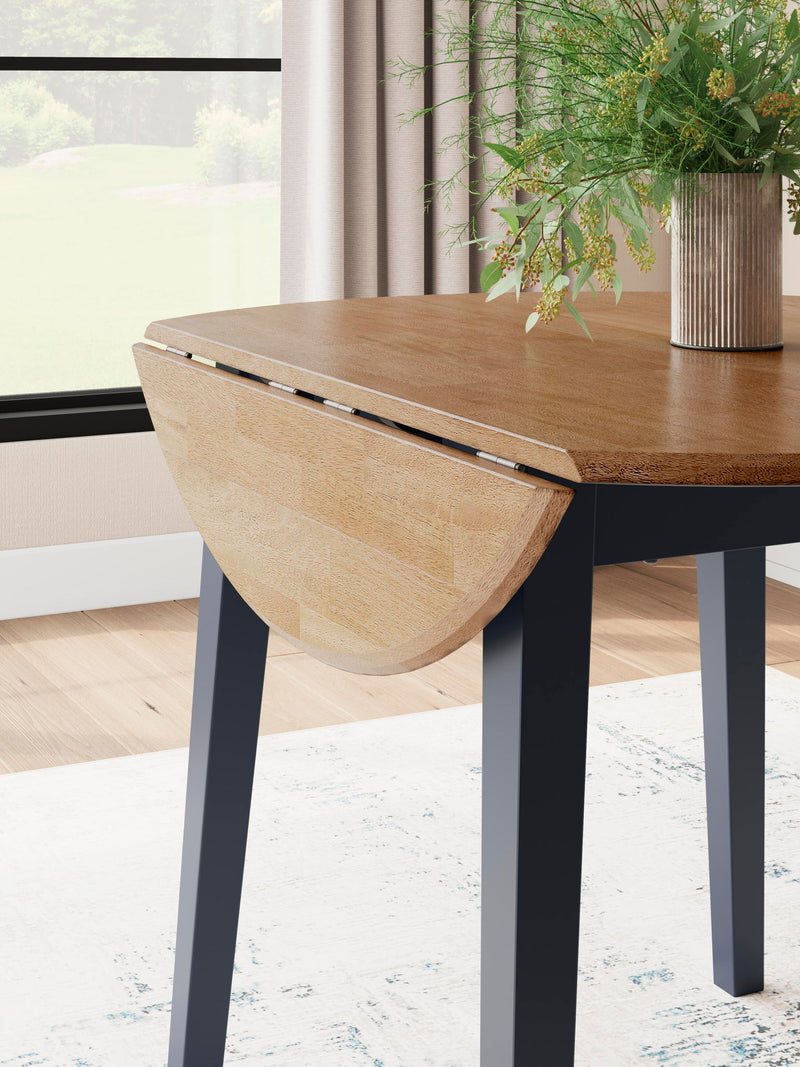 Round dining room drop leaf table by Signature Design by Ashley, featuring a wooden surface and classic design.