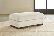 Signature Design by Ashley Maggie upholstered ottoman with soft fabric and cushioned top, ideal for living room or lounge area.
