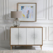 White Dani 4-door accent cabinet by Uttermost with sleek modern design and clean lines, shown with closed doors.