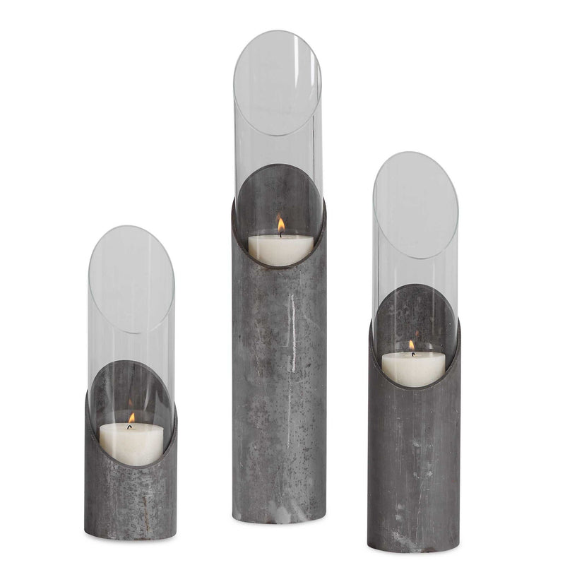 Set of three Uttermost Karter iron and glass candleholders in pearl silver and dark gray, featuring sleek modern design.