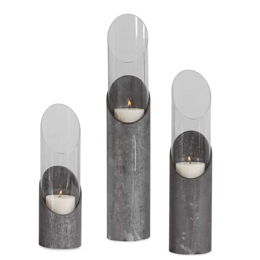 Set of three Uttermost Karter iron and glass candleholders in pearl silver and dark gray, featuring sleek modern design.