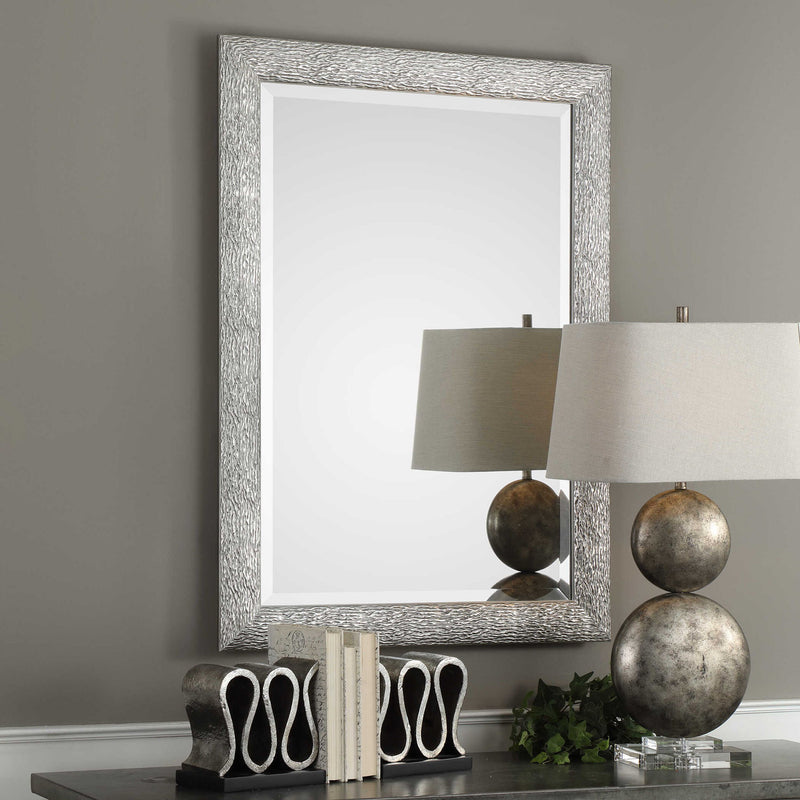 Uttermost Mossley metallic silver wall mirror with a round, textured frame perfect for modern home decor.