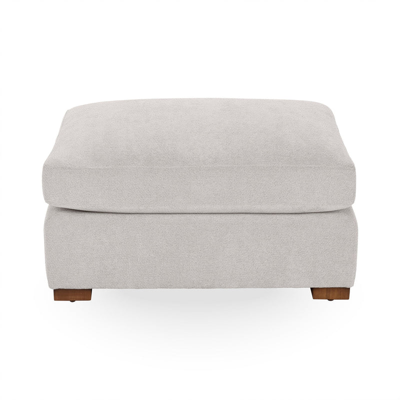 Classic Home Audrey upholstered ottoman with a tufted fabric top and wooden legs, showcasing elegant and comfortable design.