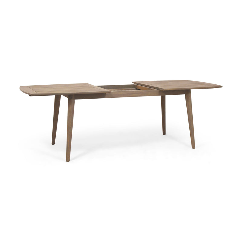 Noble House Placidity outdoor expandable dining table with slatted tabletop and tapered legs, suitable for patio or garden dining.