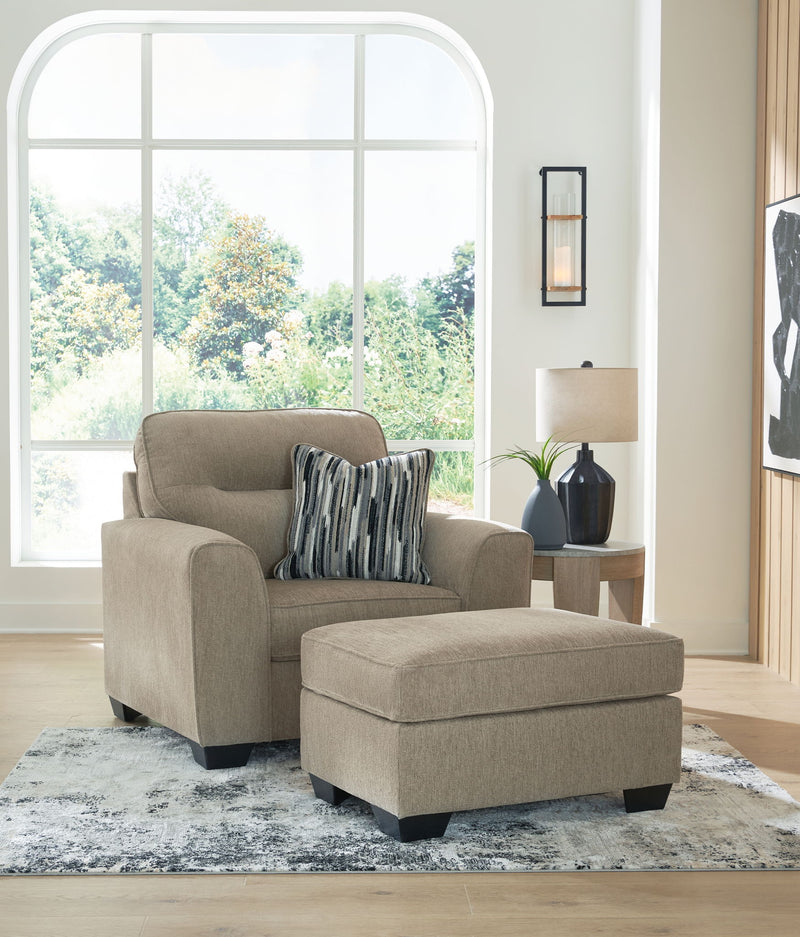 Benchcraft Olten stationary living room set with a comfortable chair and matching ottoman, featuring plush upholstery and modern design.