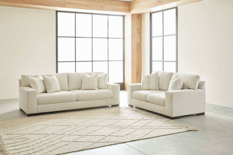 Signature Design by Ashley Maggie living room set with stationary chair and ottoman in a cozy, modern home interior.