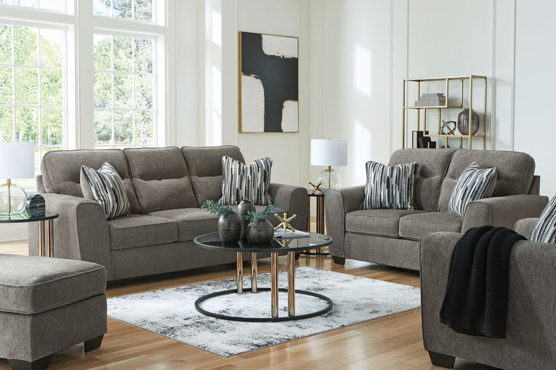 Benchcraft Olten living room set with stationary chair and matching ottoman, featuring plush upholstery and modern design.