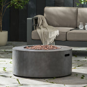 Round iron fire pit by Noble House with 40,000 Btu, featuring a sturdy design and open flame area for outdoor heating and ambiance.