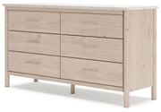 Signature Design by Ashley six-drawer dresser with sleek wood finish and modern hardware, offering ample storage space.