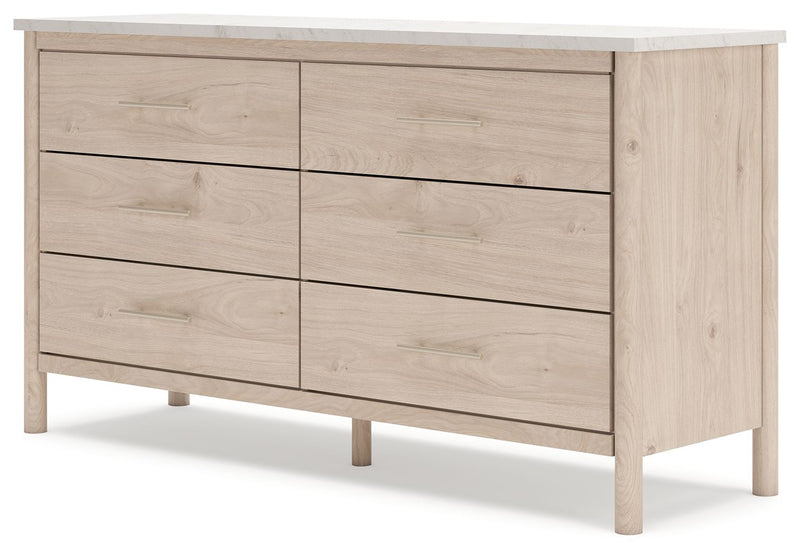 Signature Design by Ashley six-drawer dresser with sleek wood finish and modern hardware, offering ample storage space.