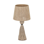TOV Furniture Samba table lamp with a sleek, modern design featuring a cylindrical base and fabric shade on a wooden table.