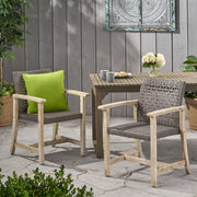 Set of two Noble House outdoor dining chairs with acacia wood frames and slatted seats, ideal for patio or garden seating.