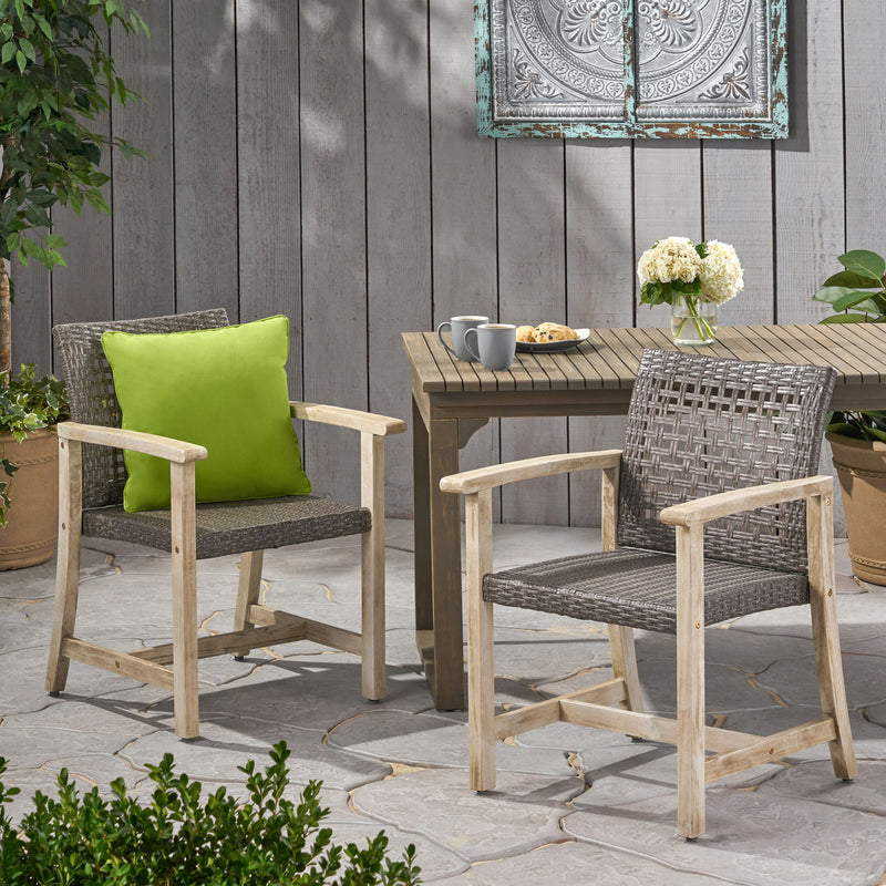 Set of two Noble House outdoor dining chairs with acacia wood frames and slatted seats, ideal for patio or garden seating.