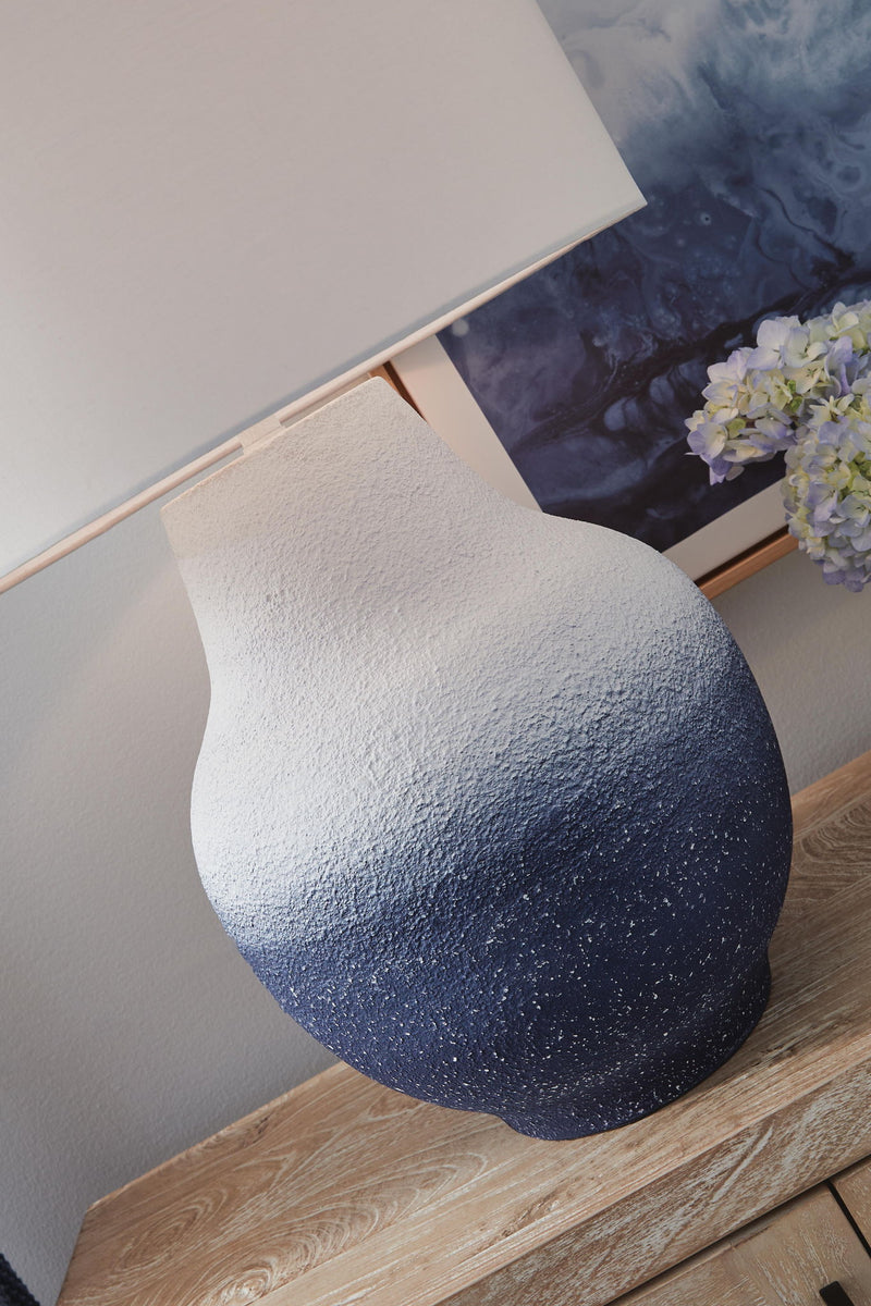 White and navy metal table lamp from Dashland by Signature Design Ashley, featuring a sleek modern design.