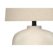 Modern cream resin table lamp by 8th Street featuring a sleek, minimalist design for stylish home lighting.