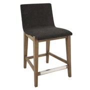 Uttermost Klemens counter stool with dark wood legs and a plush upholstered seat, designed for counter height seating.